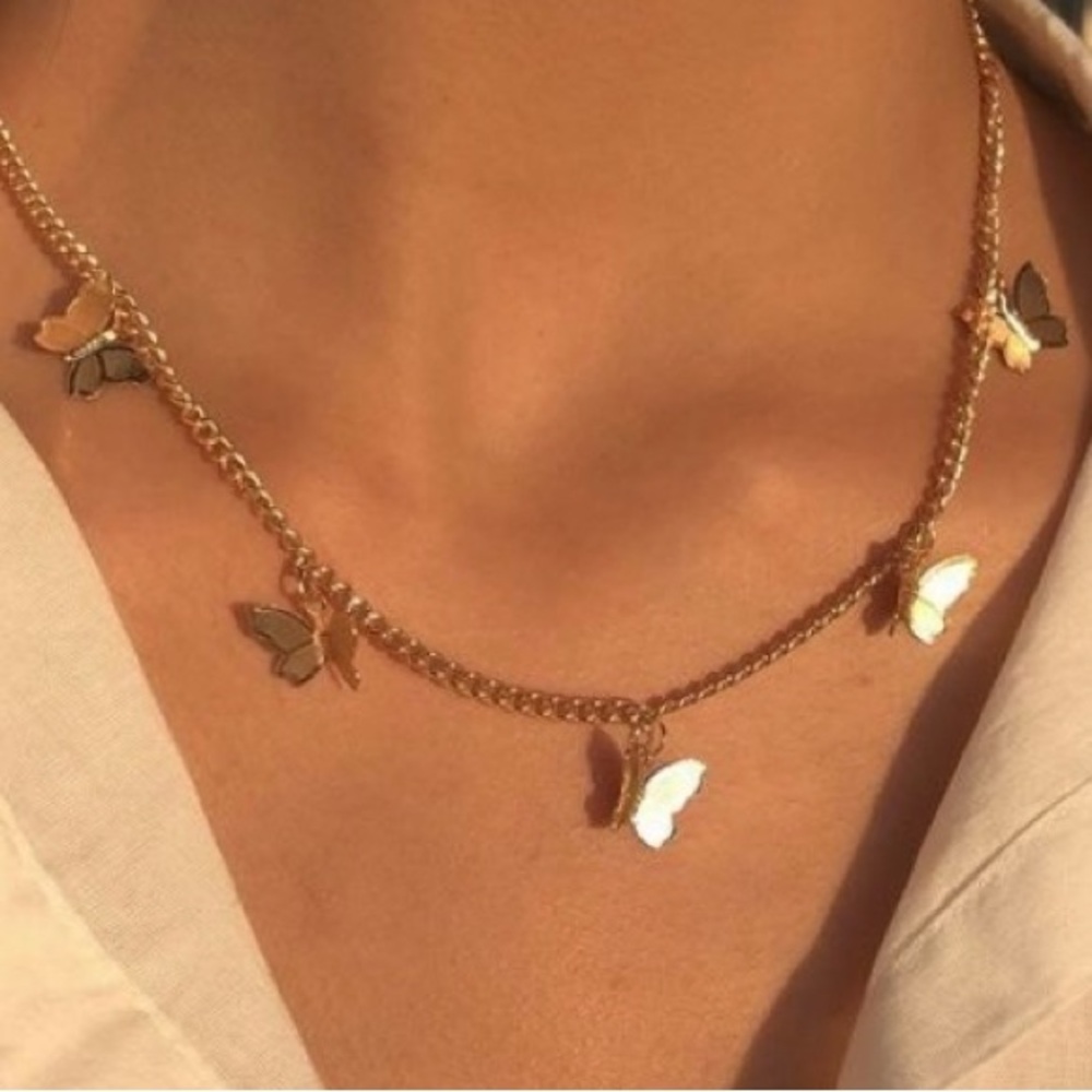 New never worn in pack Charming Gold toned stainless steel Butterfly Necklace .
